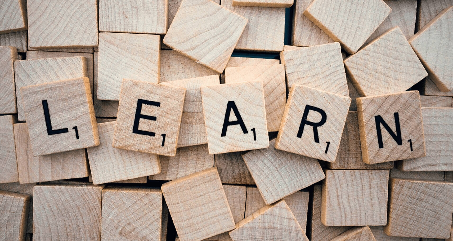 A picture of scrabble pieces spelling out 'learn'.